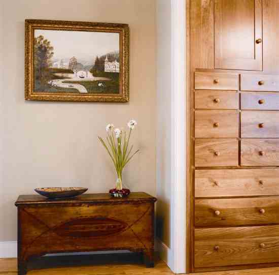 Michele, whose father is an antique dealer, grew up loving the classic New England painted blanket chest that now sits in the living area. Above hangs a 19th-century folk-art Hudson River Valley landscape painting that the couple appreciates because of its childlike whimsy.